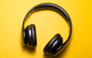 Big black headphones on a yellow background