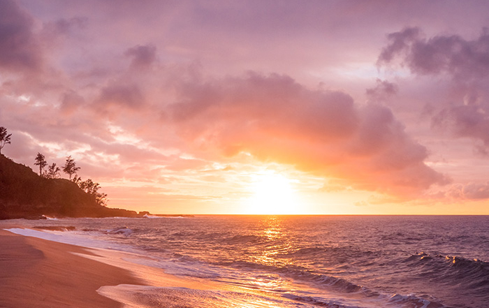 Serene purple sunset at a beach.